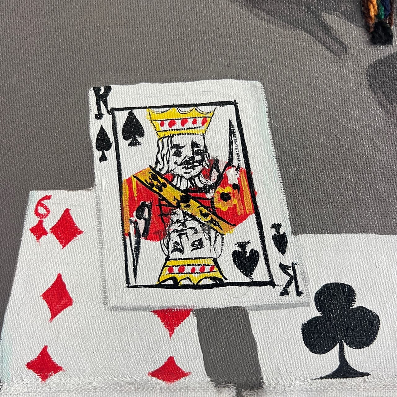 Detail of All In, Still Calm showing painted playing cards on the table