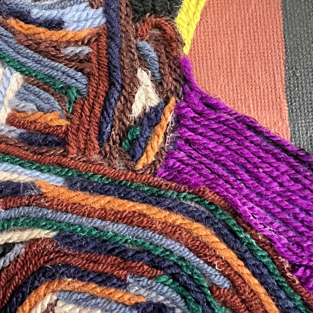 Detail of All In, Still Calm showing layered yarn texture across the figure's face and jacket